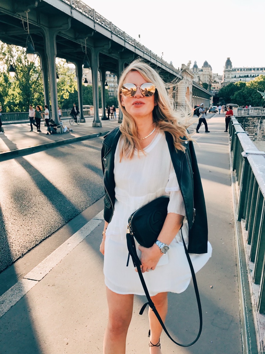Stacey Ohlemann wearing sunglasses on a Paris bridge